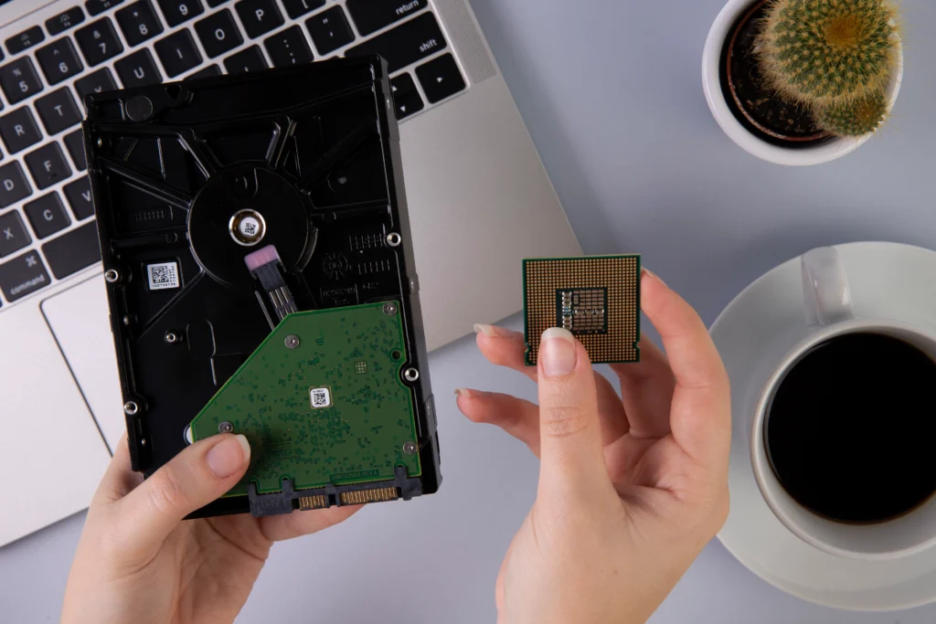 "Which GPU Offers the Best AI Performance Under $500? CPU and hard drive beside a laptop for AI PC upgrade."